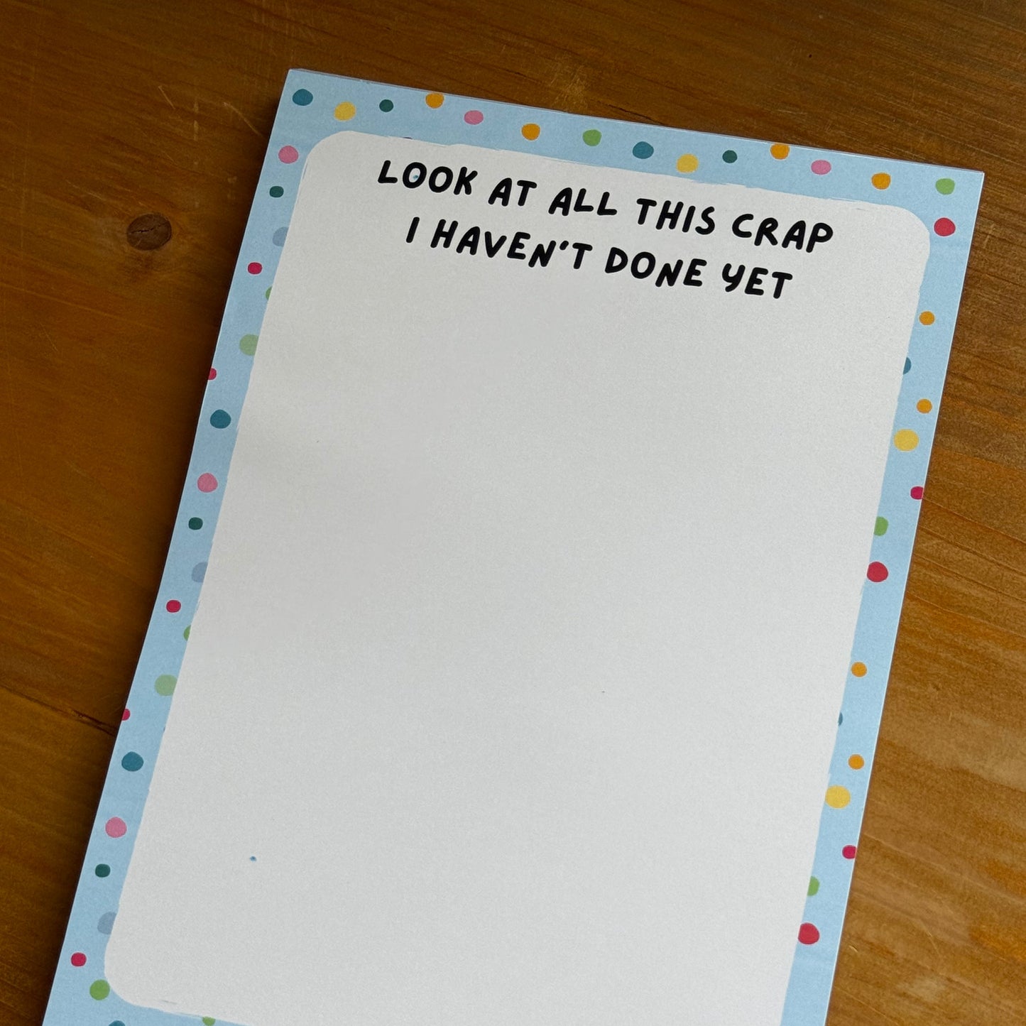 Note pad with text on a wooden surface