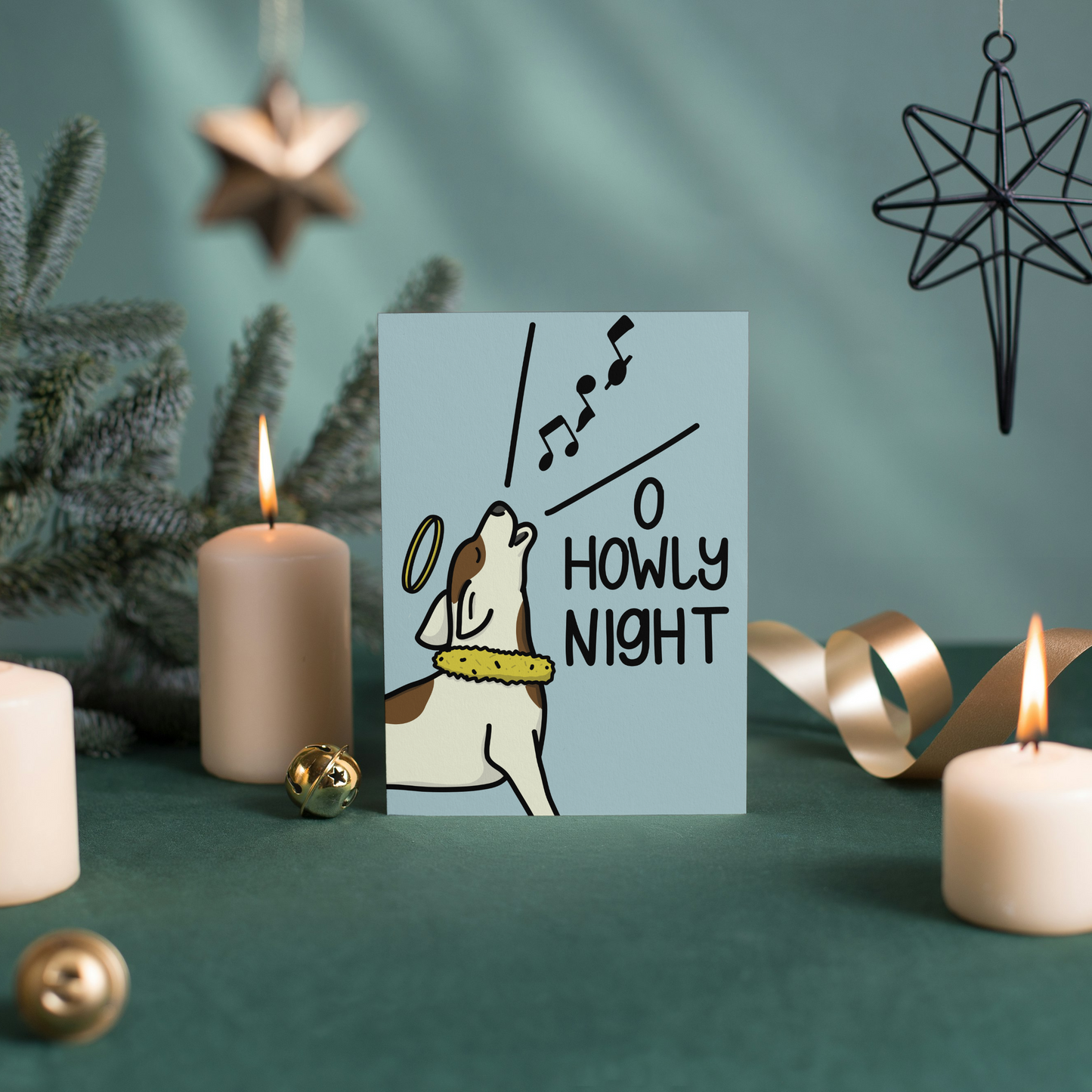 Card with dog illustration and 'O Howly Night' text surrounded by candles and Christmas decorations on a green background