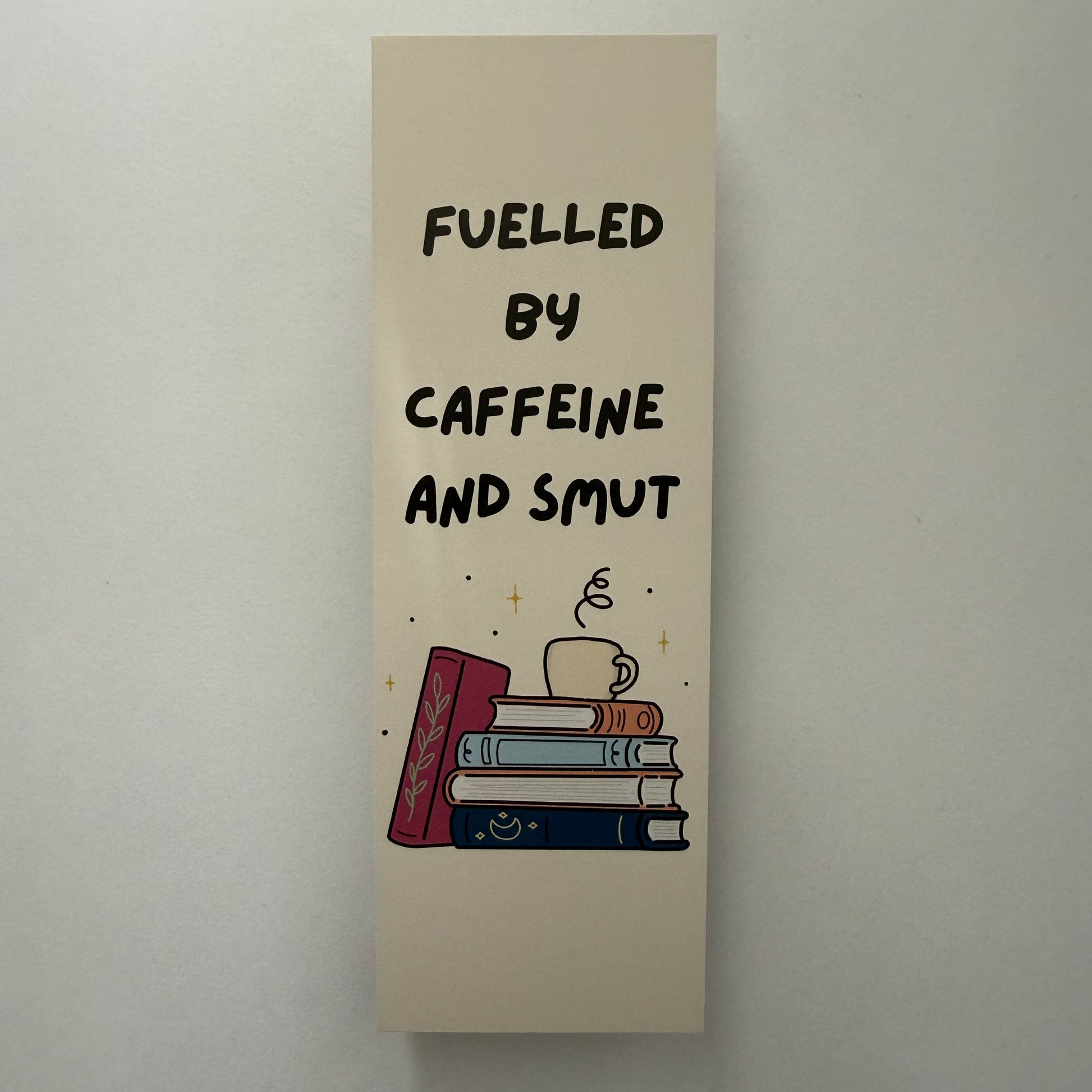 Decorative bookend with text 'Fueled by caffeine and slut' on a plain background