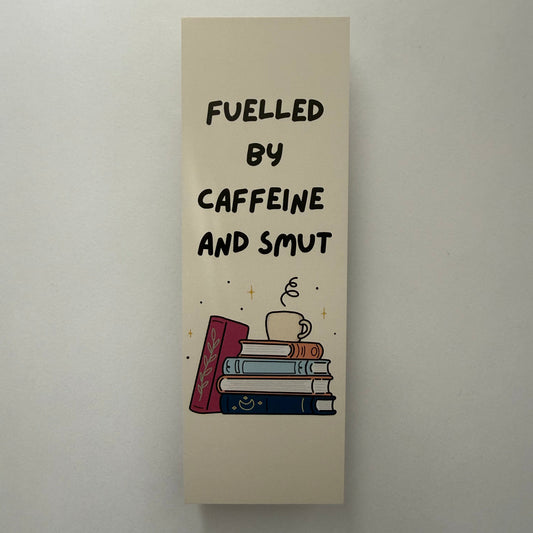 Decorative bookend with text 'Fueled by caffeine and slut' on a plain background