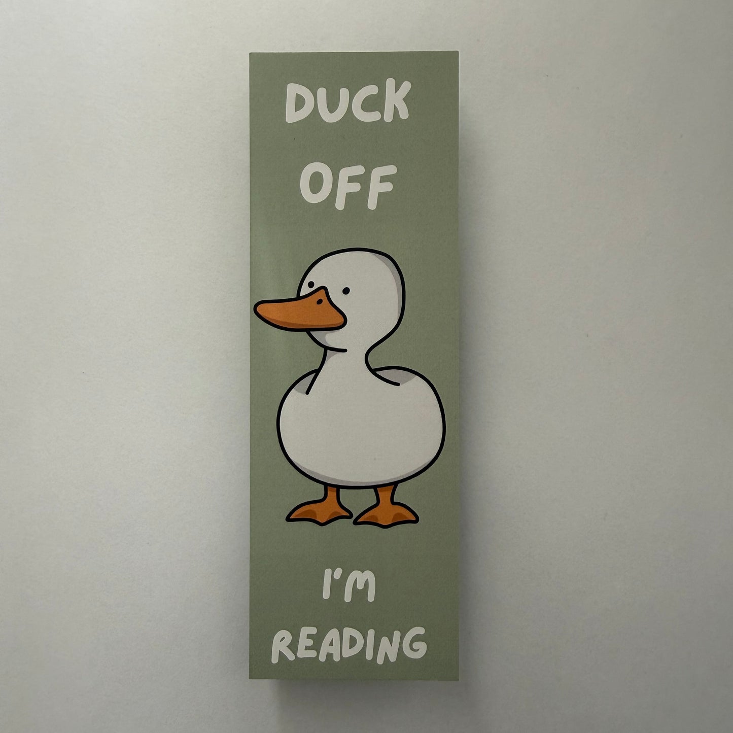 Bookmark with a duck illustration and text on a plain background