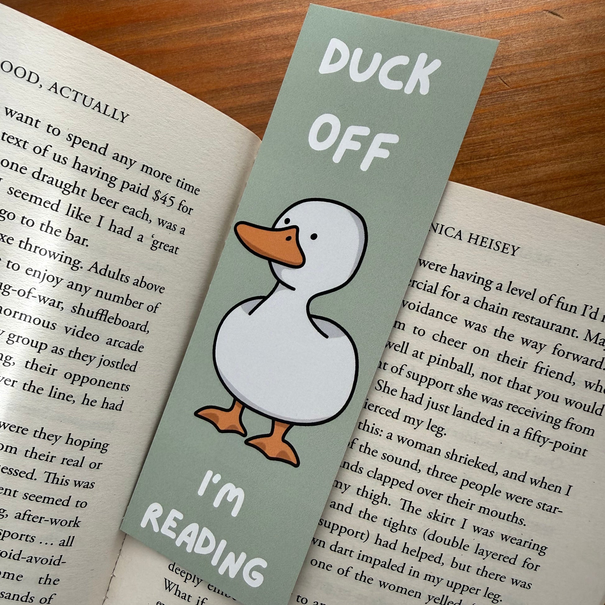 Bookmark with duck illustration and text on a book