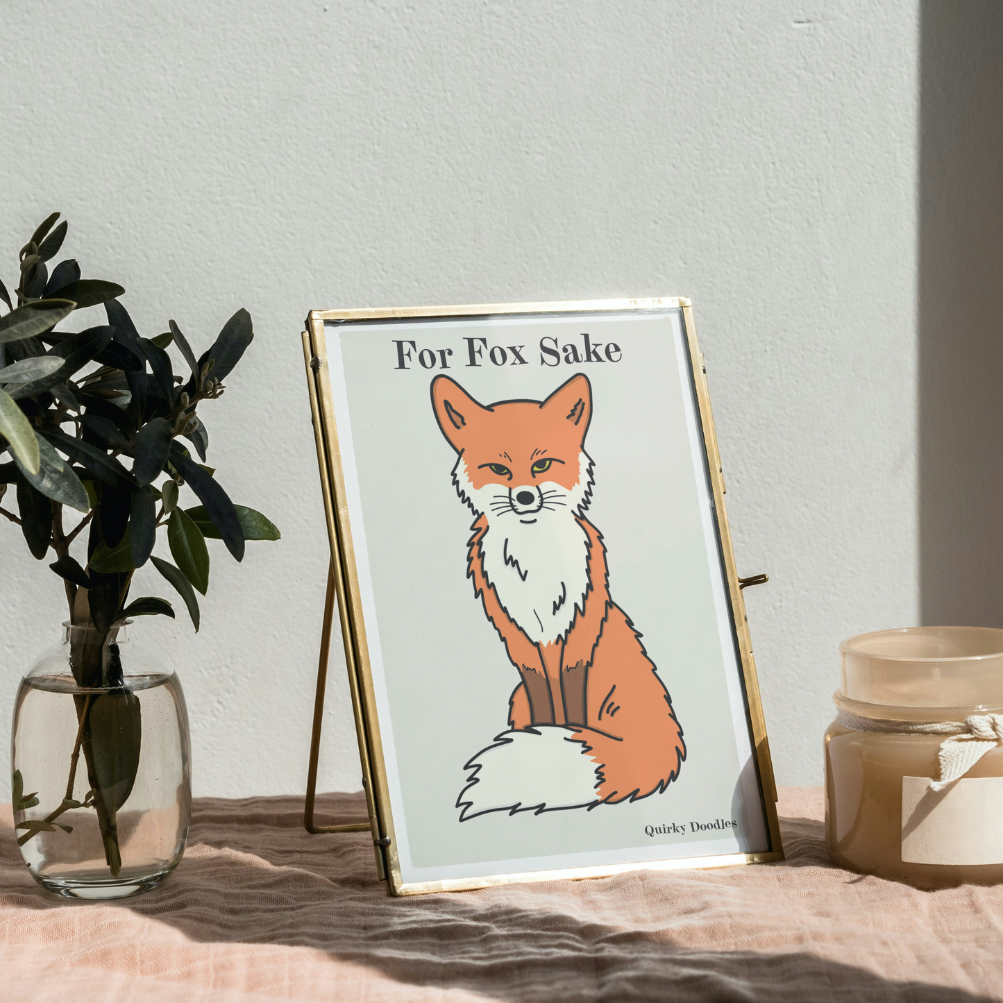 Gold frame with an image of a fox illustration, the words For Fox Sake above