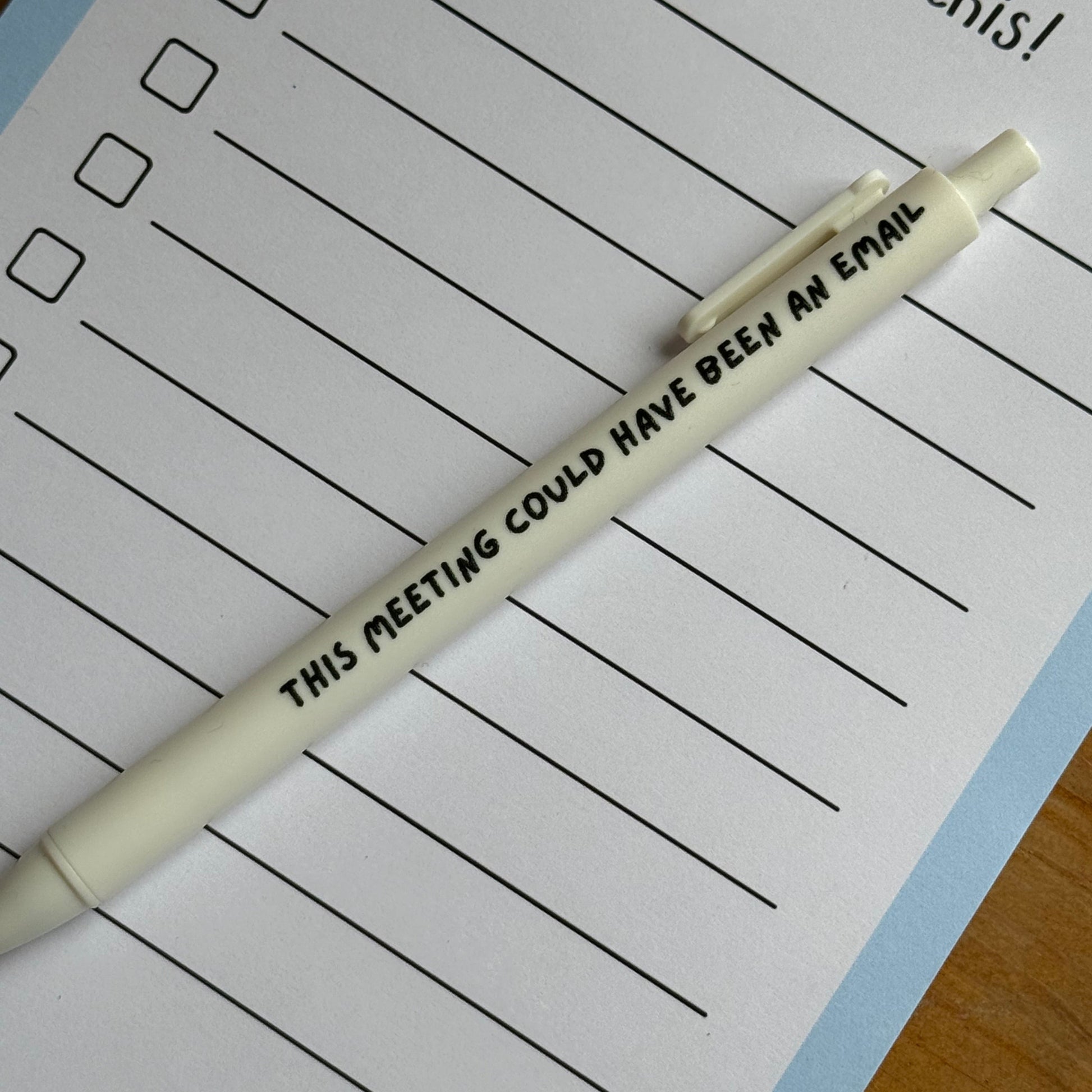 White pen on a lined notepad with cartoon goose illustration
